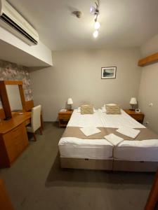 Posteľ alebo postele v izbe v ubytovaní Lugas Hotel