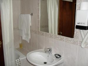 a bathroom with a sink and a mirror at Flor Do Douro - Comércio e Hotelaria, Lda in Miranda do Douro +47 photos