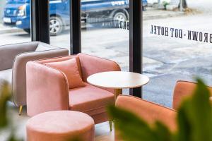 a couple of chairs and a table in front of a window at Browndot Hotel Namchuncheon in Chuncheon