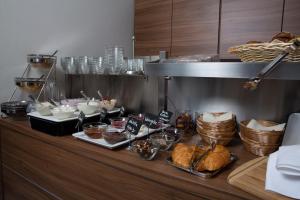- un buffet avec du pain et d'autres produits alimentaires sur un comptoir dans l'établissement Weingut Schreieck VINOTEL & GUTSHAUS, à Sankt Martin