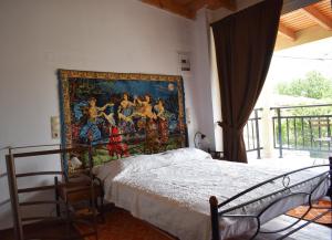 a bedroom with a painting on the wall next to a bed at Ethia 2Floor Mountain View Cottage garden wifi ac in Ethiá