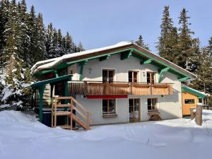 a house with a balcony in the snow at Haus Katschberg in Katschberghöhe