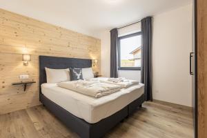 - une chambre avec un grand lit et une fenêtre dans l'établissement Inzell Chalets by ALPS RESORTS, à Inzell
