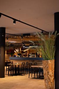 a dining room with tables and chairs and a counter at Corno Bianco in Nova Ponente