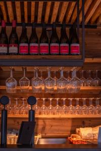a display of wine glasses and wine bottles at Corno Bianco in Nova Ponente