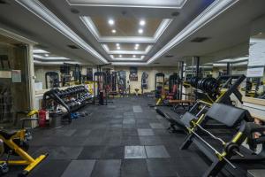 a gym with several treadmills and machines at The Green Park Taksim in Istanbul