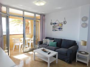 a living room with a couch and a table at El Rincón de Maruca Primero C in Gran Tarajal +20 photos