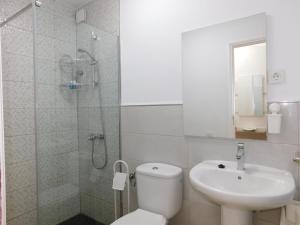 uma casa de banho com um WC, um lavatório e um chuveiro em El Rincón de Maruca Primero C em Gran Tarajal