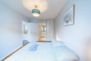 a bedroom with a blue bed in a room at Charming T2 (44M2) bright with Terrace in Villeurbanne
