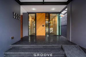 a hallway with a door with the word groove at GROOVE AT SIAM in Pom Prap