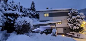 a house with a pile of snow in front of it at Residence Alba Montis in Bad Kleinkirchheim
