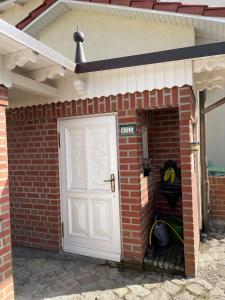 a brick house with a white door and a garage at Villa Waldrose in Binz