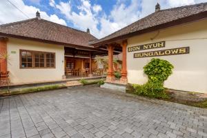 a building with a sign on the side of it at Bon Nyuh Bungalows in Gianyar