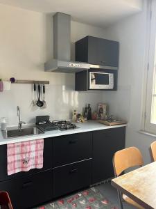 a kitchen with a sink and a stove top oven at The Queen in Rome