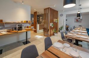 a dining room and kitchen with a long table and chairs at Seven Seas Residence in Split
