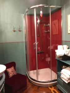 baño con ducha con pared roja en L'Ape Regina, en Ferrara