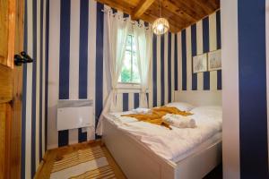 a bedroom with a bed with a teddy bear on it at ACTIVFARM DOMKI NA KASZUBACH Domek Piotruś in Gliśno
