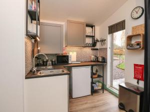 a small kitchen with a sink and a microwave at Backstage in Pitlochry