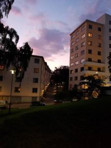 a city street with two tall buildings and a building at Quite room in apartement in Oslo