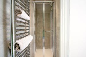 a shower with towels on a towel rack in a bathroom at Sunridge EcoPod with Private Hot Tub in Plymouth