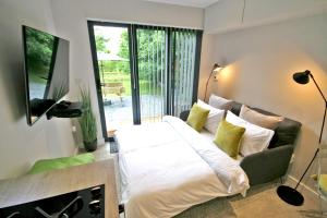 a bedroom with a bed and a television in it at Sunridge EcoPod with Private Hot Tub in Plymouth