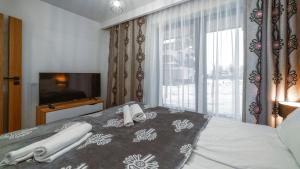 Posteľ alebo postele v izbe v ubytovaní Resorts E Białka Tatrzańska z sauną, Sun & Snow