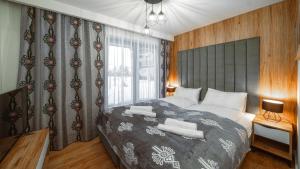Posteľ alebo postele v izbe v ubytovaní Resorts E Białka Tatrzańska z sauną, Sun & Snow