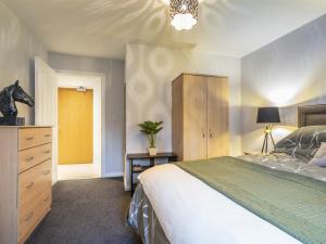 a bedroom with a large bed and a dresser and a dresser at Luxury Living Cathedral Quarter Cafes Bars in Belfast