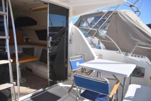Blick auf das Innere eines Bootes mit einem Tisch und Stühlen in der Unterkunft Luxury Yacht Kamikara in San Miguel de Abona
