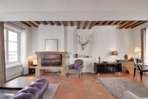 a living room with a couch and a fireplace at Apartments for Work in City Center in Paris