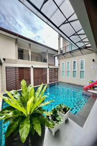 a swimming pool in the middle of a house at Sivana Place Phuket in Bang Tao Beach