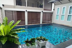 a swimming pool in the middle of a house at Sivana Place Phuket in Bang Tao Beach