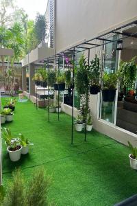 a courtyard with potted plants on the side of a building at Sivana Place Phuket in Bang Tao Beach