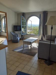 a living room with a couch and a table at La Bleuette in Montmaur