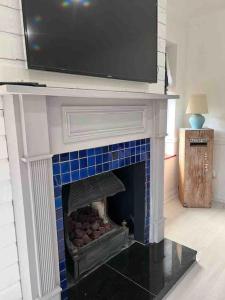 a fireplace with a tv on top of it at No. 19 in Rostrevor