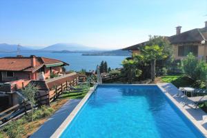 a swimming pool with a view of the water at Penthouse Andrea in Meina