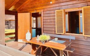 a wooden cabin with a wooden table and a bench at Le Dune Villaggio in Lido Di Fondi