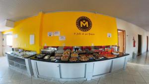 a bakery with a counter filled with different types of pastries at Hotel Jerusalém 2 in Goiânia