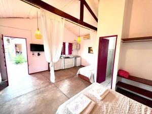 a large room with two beds and a kitchen at Gostoso Familly Chalés - Beira Mar in São Miguel do Gostoso +1 photo