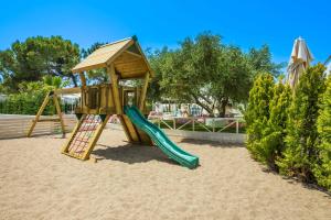 a playground with a slide in the sand at Cocoοns Suites & Villas Fourka in Fourka