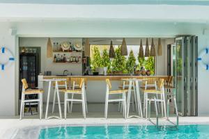 a kitchen and dining area with a swimming pool at Cocoοns Suites & Villas Fourka in Fourka