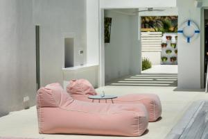 a pink bean bag chair in a living room at Cocoοns Suites & Villas Fourka in Fourka