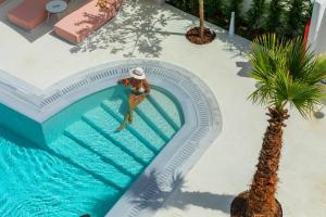 an overhead view of a man in a swimming pool at Cocoοns Suites & Villas Fourka in Fourka