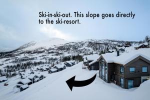a town covered in snow with two arrows pointing to a house at The Panorama Retreat - Rindabotn Cabin in Sogndal +41 photos