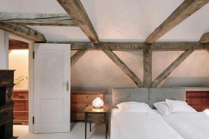 a bedroom with two beds and a wooden ceiling at Apartment Alte Schmiede in Saal