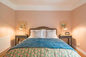 a bedroom with a large bed with two night stands at Cliffeside Cottage in Kingsdown
