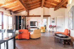 - un salon avec des chaises orange et une table dans l'établissement Casa Peler al Benaco - Style, Lake view & Pool, à Toscolano Maderno