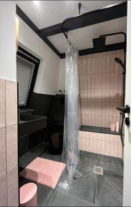 a bathroom with a shower with plastic wrap on it at Kustverhuur, Park Schoneveld, Zeester 49 in Breskens