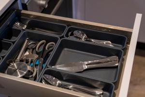 a drawer full of utensils in a kitchen at Super Cosy Apartment in The Heart Of Chelmsford in Chelmsford