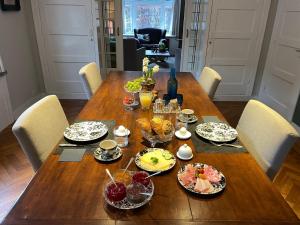 una mesa de madera con platos de comida. en Florentino en Eindhoven